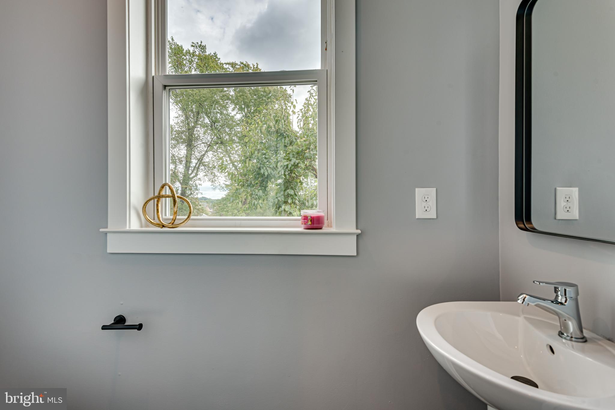 3830 First Street Southeast Washington, DC 20032 - Photo 15 of 49 a bathroom with a sink and a window