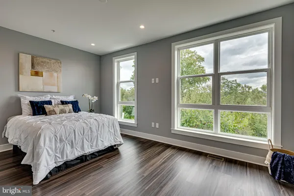 a spacious bedroom with a large bed and a large window