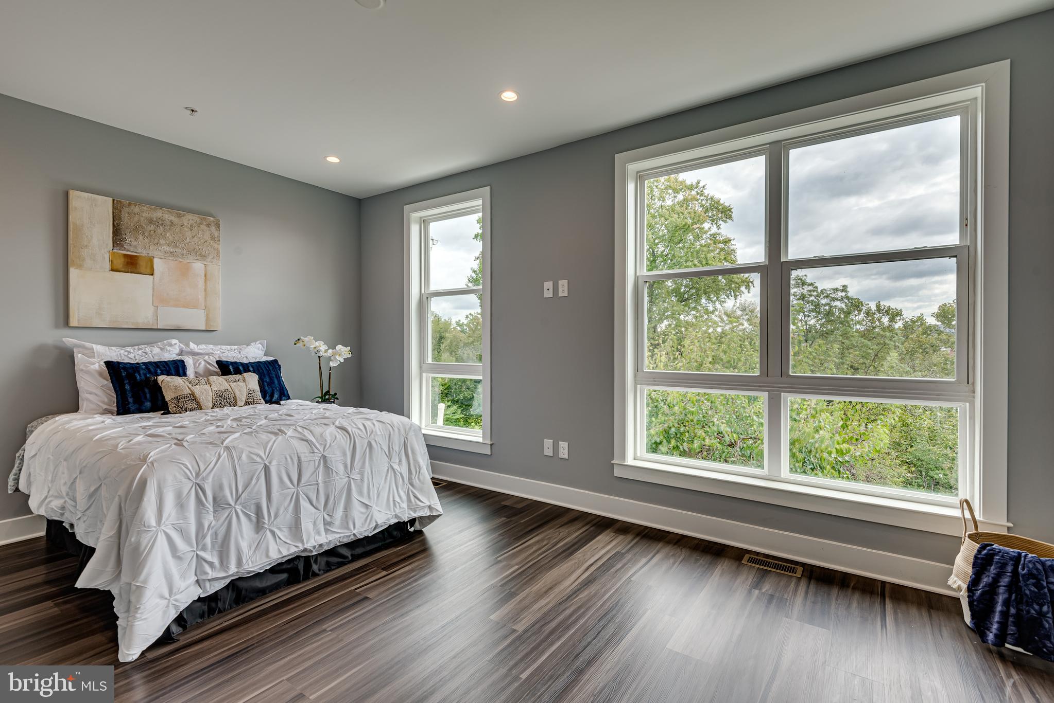 3830 First Street Southeast Washington, DC 20032 - Photo 20 of 49 a spacious bedroom with a large bed and a large window