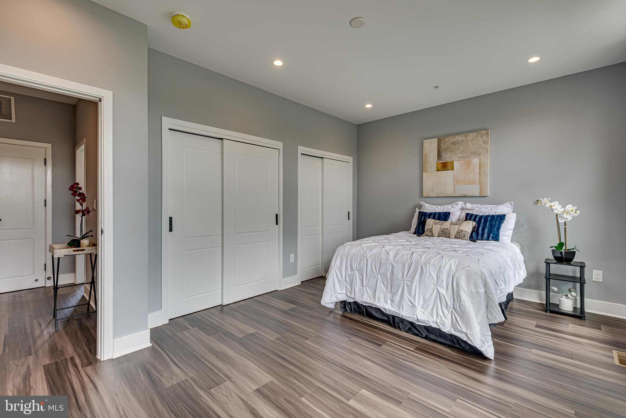 3830 First Street Southeast Washington, DC 20032 - Photo 21 of 49 a spacious bedroom with a bed and a wooden floor