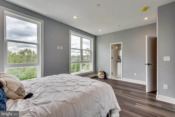 a spacious bedroom with a large bed and a window