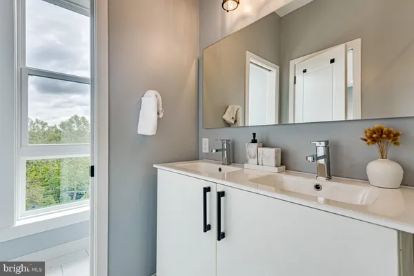 a bathroom with a sink vanity and mirror