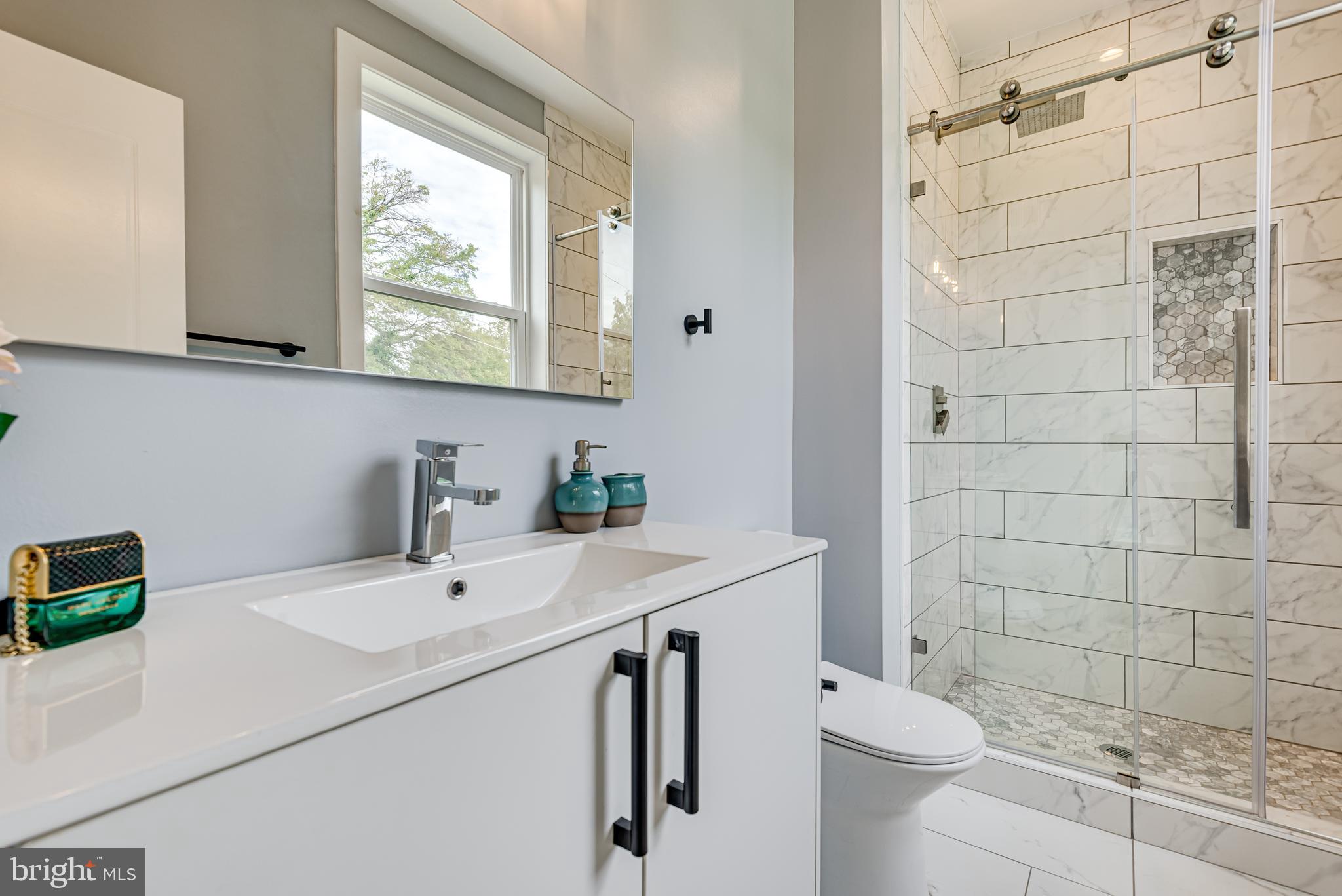 3830 First Street Southeast Washington, DC 20032 - Photo 25 of 49 a bathroom with a sink a toilet and a mirror
