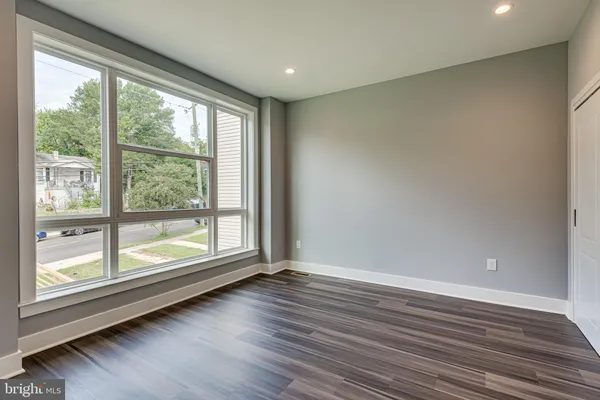 a view of room with window and wooden floor
