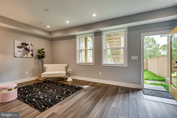a living room with wooden floor and a window