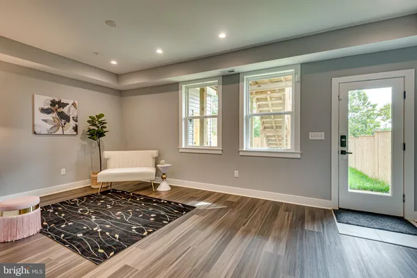 a living room with a rug and a window