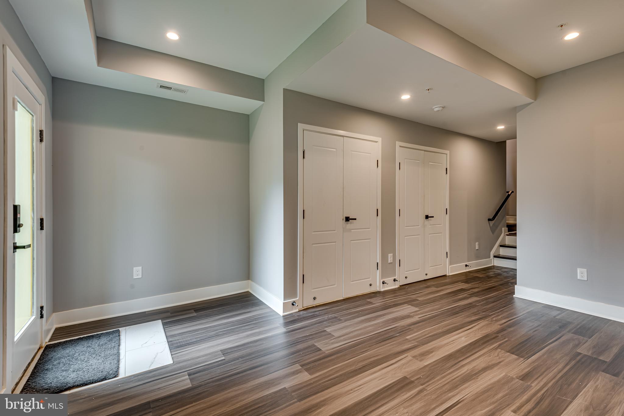 3830 First Street Southeast Washington, DC 20032 - Photo 38 of 49 an empty room with wooden floor and windows