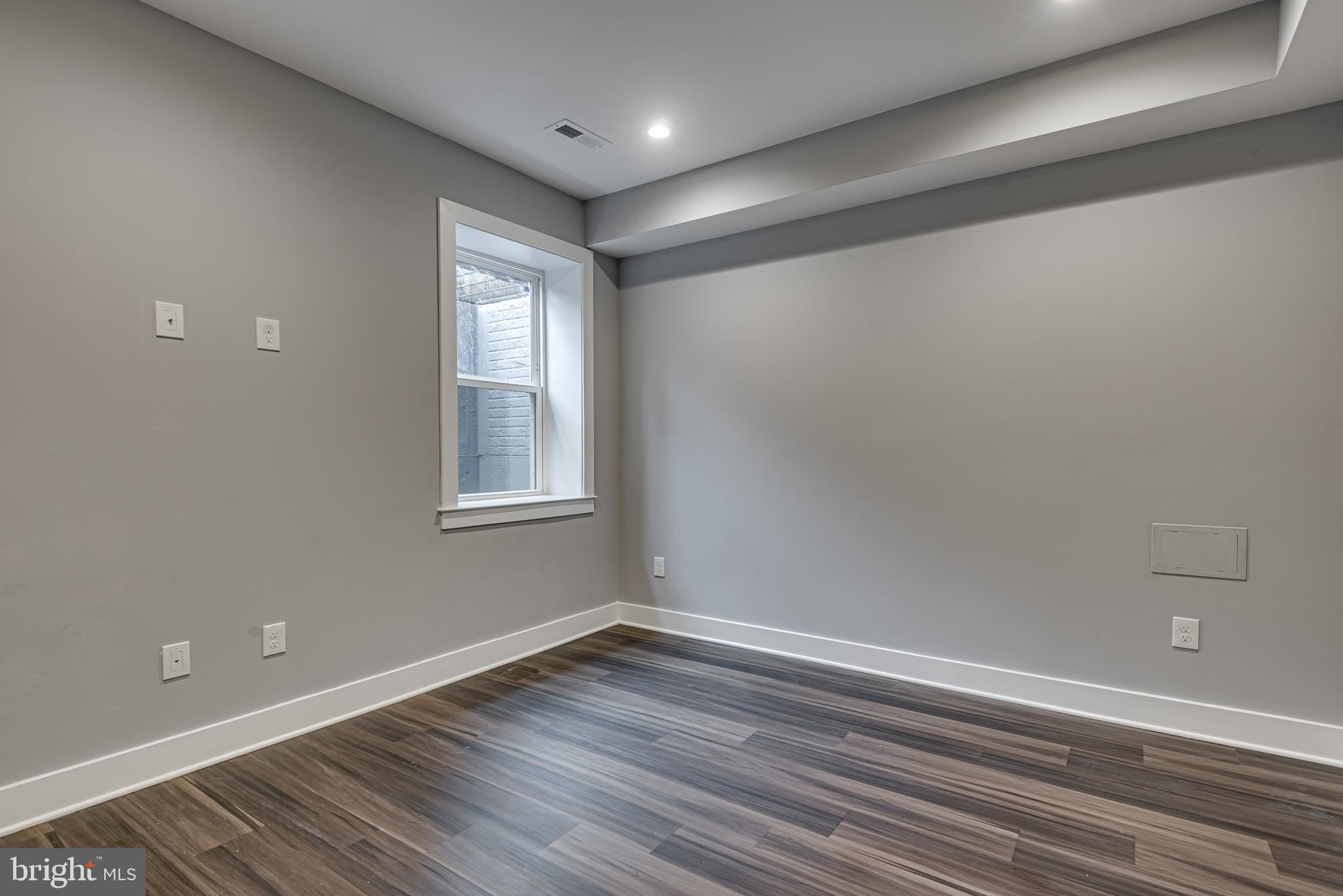 3830 First Street Southeast Washington, DC 20032 - Photo 43 of 49 a view of an empty room with wooden floor and a window