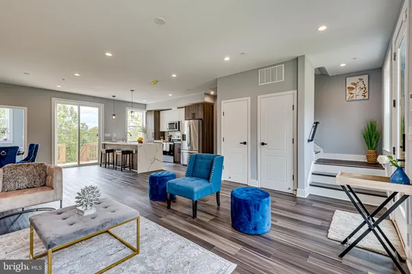 a living room with furniture or couch and a wooden floor