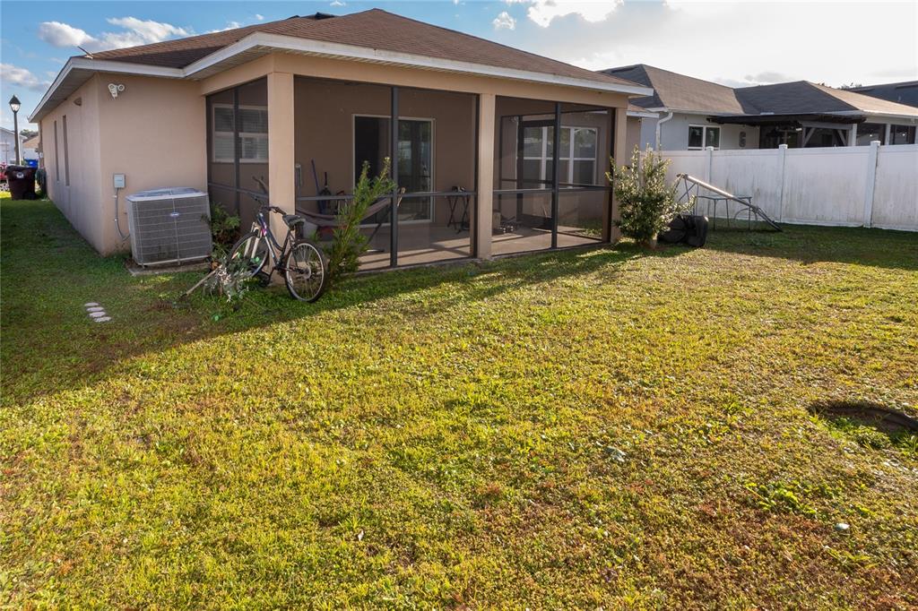4563 Orchard Grove Road St. Cloud, FL 34772 - Photo 10 of 51 a view of a house with backyard and porch
