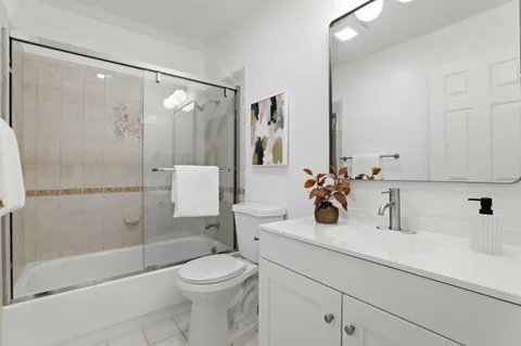 a bathroom with a sink a toilet and shower