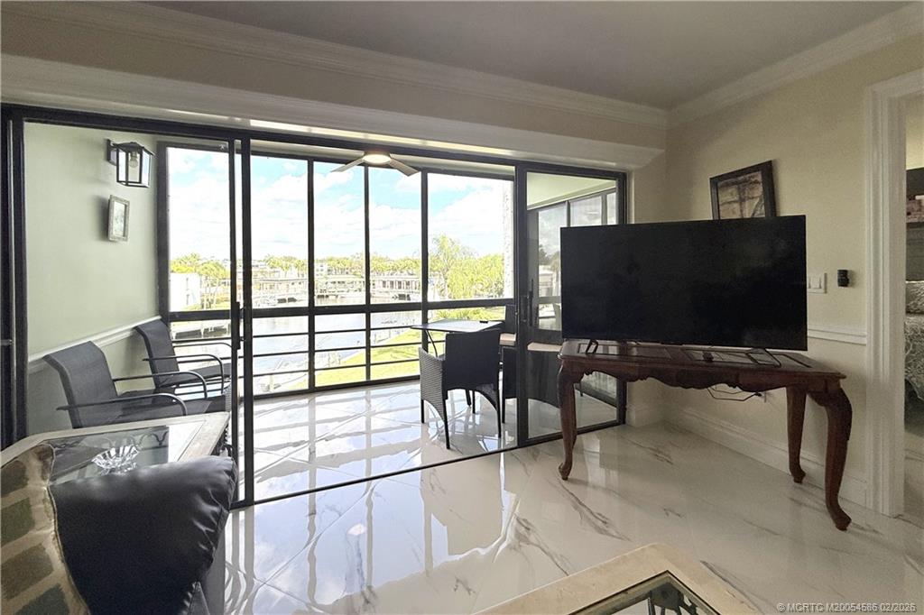 1950 Southwest Palm City Road, Unit 3309 Stuart, FL 34994 - Photo 12 of 32 a view of a living room with furniture and floor to ceiling window