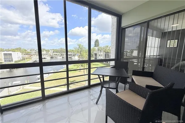 a view of a livingroom with furniture and a window