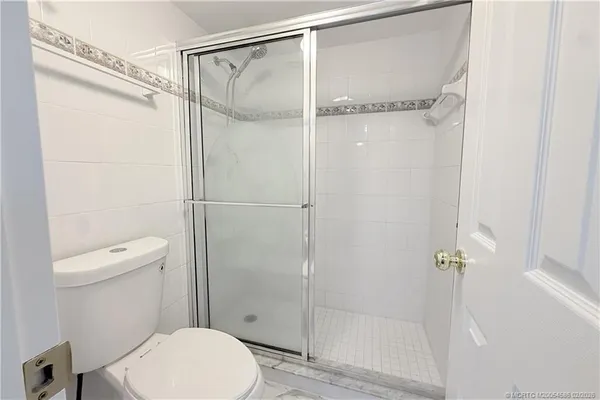 a bathroom with a toilet and a shower