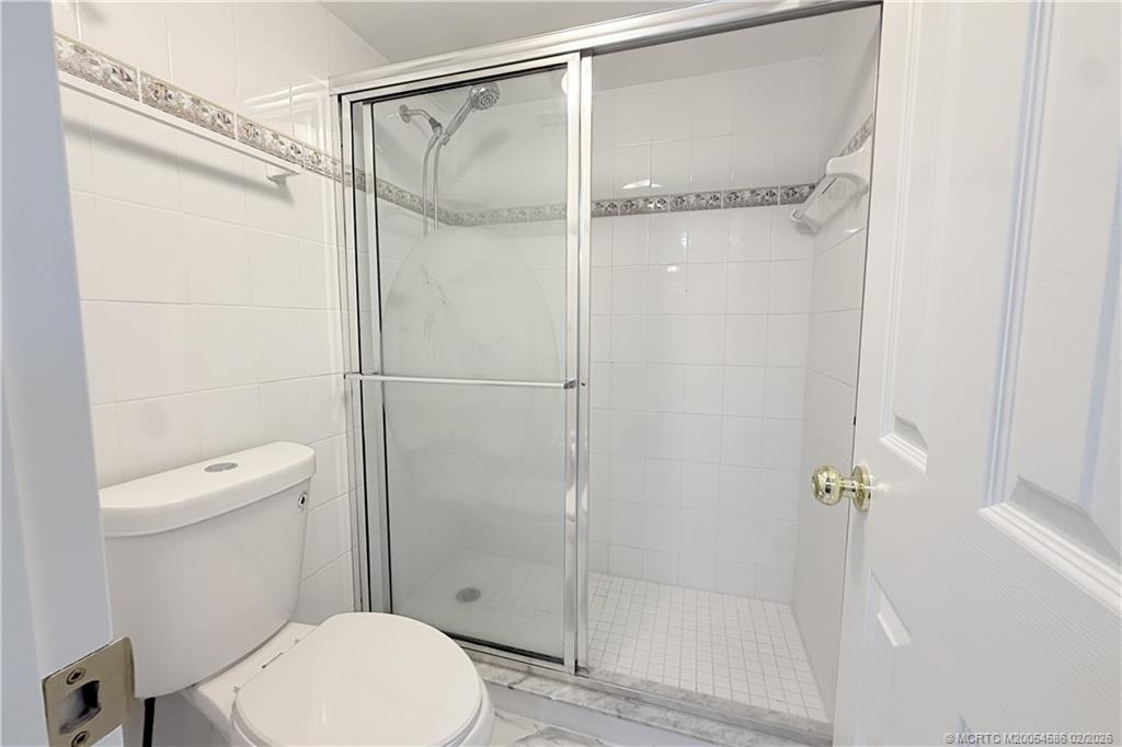 1950 Southwest Palm City Road, Unit 3309 Stuart, FL 34994 - Photo 22 of 32 a bathroom with a toilet and a shower