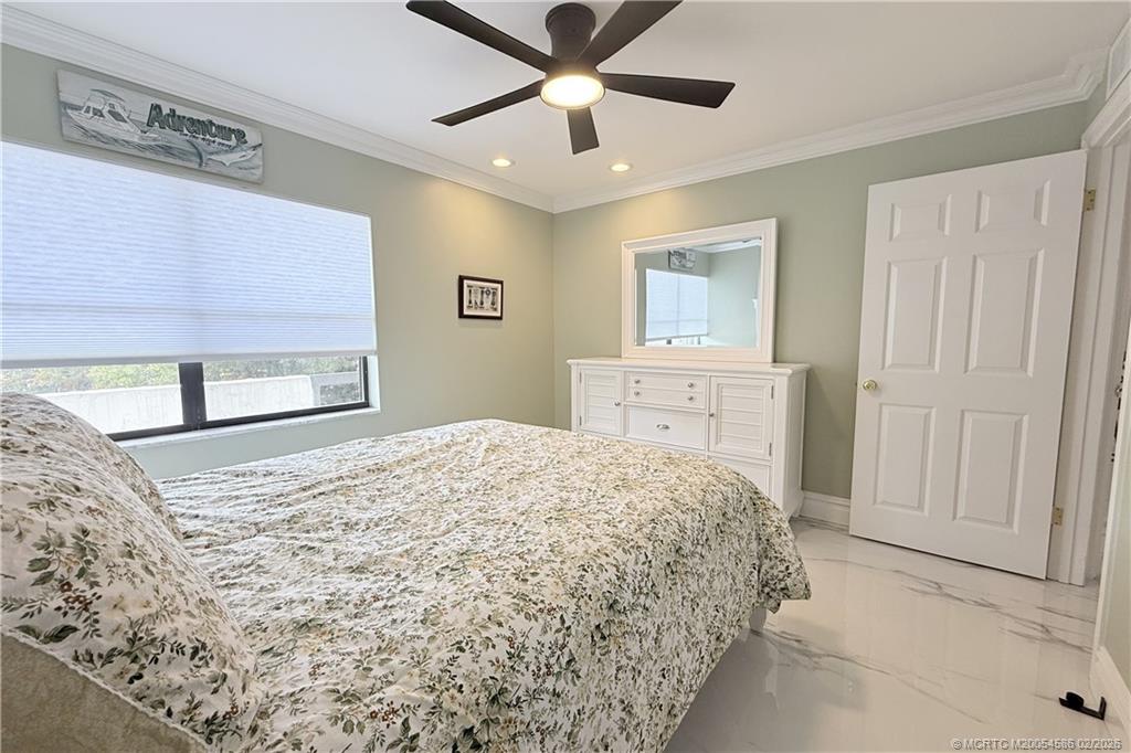 1950 Southwest Palm City Road, Unit 3309 Stuart, FL 34994 - Photo 25 of 32 a bedroom with a bed and a window