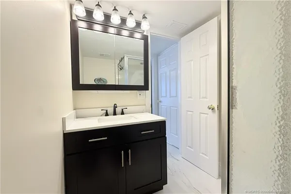 a bathroom with a granite countertop sink a mirror and a