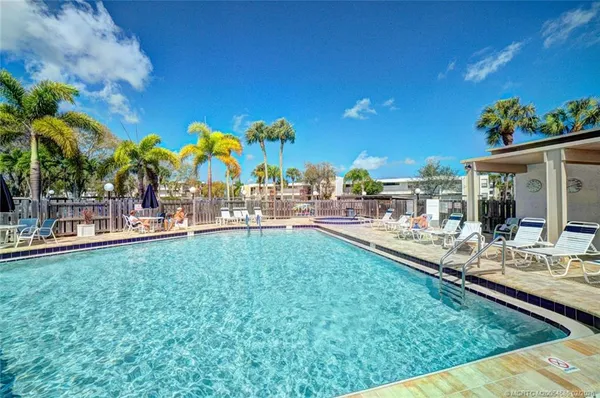 a view of swimming pool with outdoor seating