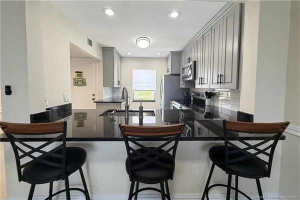 a view of a dining room with furniture and a potted plant