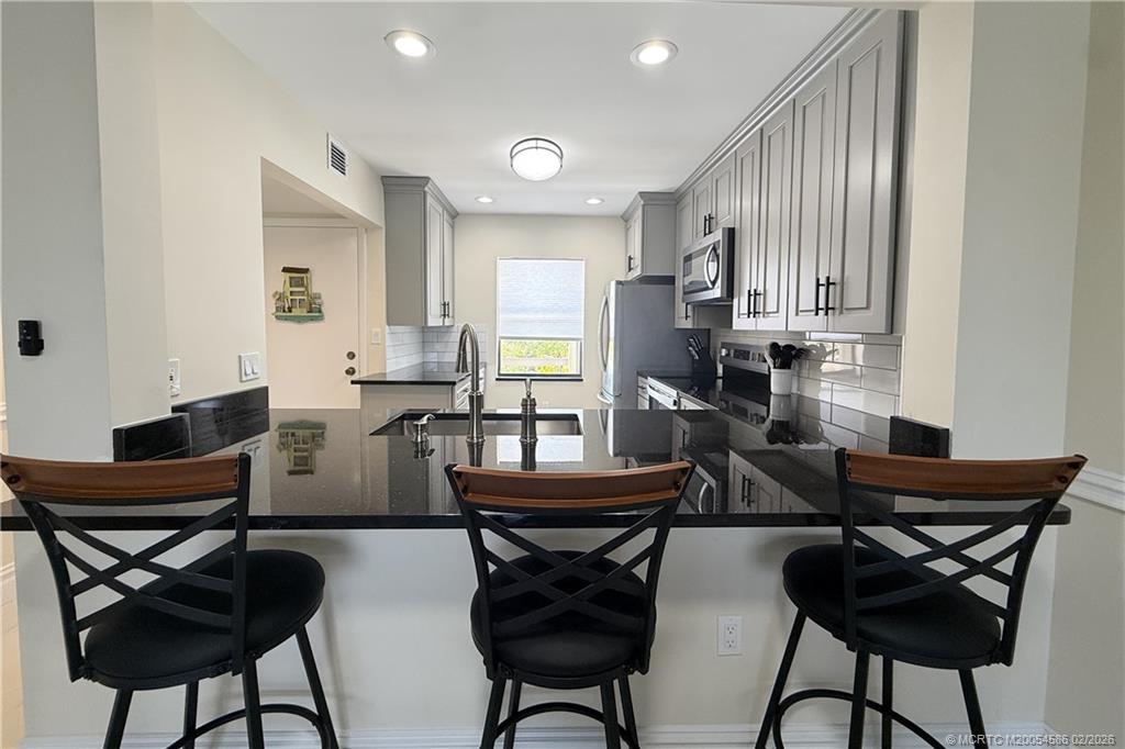1950 Southwest Palm City Road, Unit 3309 Stuart, FL 34994 - Photo 7 of 32 a view of a dining room with furniture and a potted plant