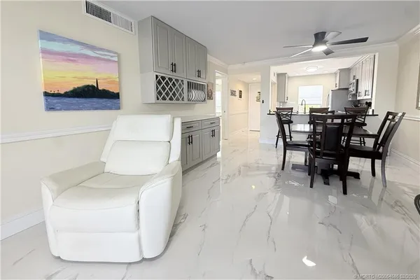 a view of a dining room with furniture and a chandelier