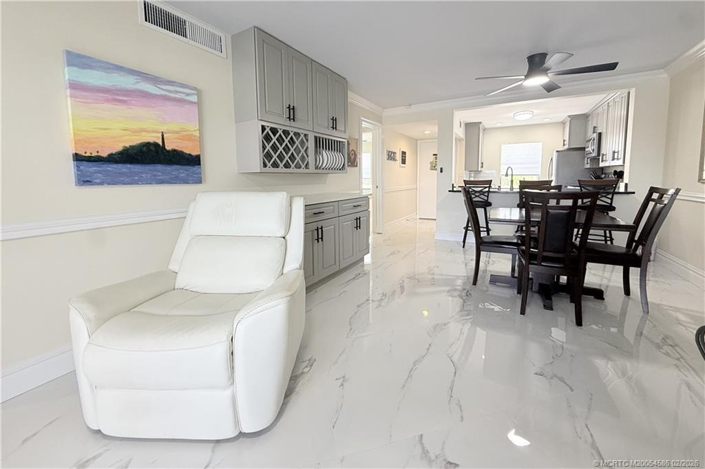 1950 Southwest Palm City Road, Unit 3309 Stuart, FL 34994 - Photo 9 of 32 a view of a dining room with furniture and a chandelier