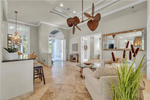a living room with kitchen island furniture and a chandelier