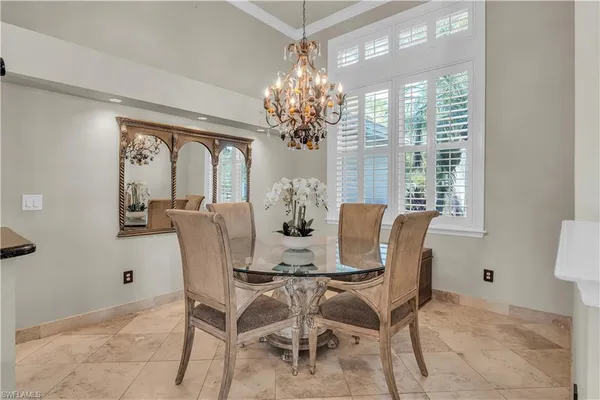 a view of a dining room with furniture and a chandelier