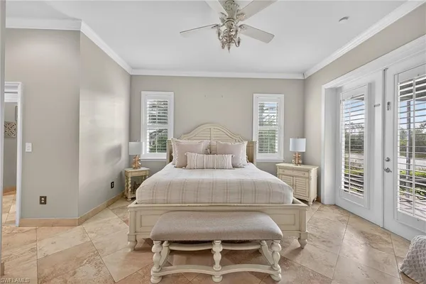 a bedroom with a bed and large windows