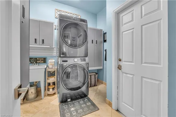 a utility room with sink dryer and washer