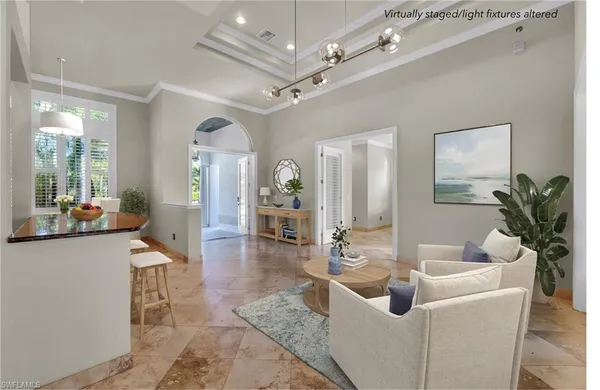 a living room with furniture and a chandelier