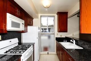 263 Ohio Street, Unit 4 Pasadena, CA 91106 - Photo 1 of 1 a kitchen with a refrigerator stove and sink