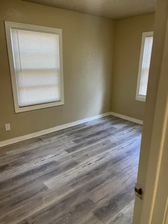 a view of small space with racks on the wall and a window