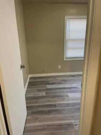 a view of a room with wooden floor and closet