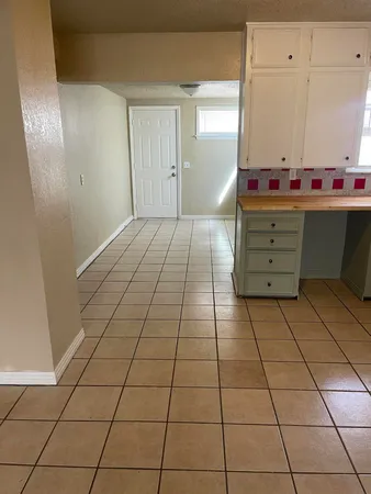 a room with washing machine and cabinets