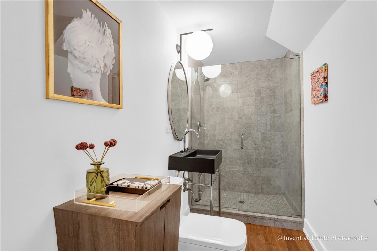 305 Clinton Avenue Elmhurst, IL 60126 - Photo 12 of 31 a bathroom with a sink a light fixture and a mirror