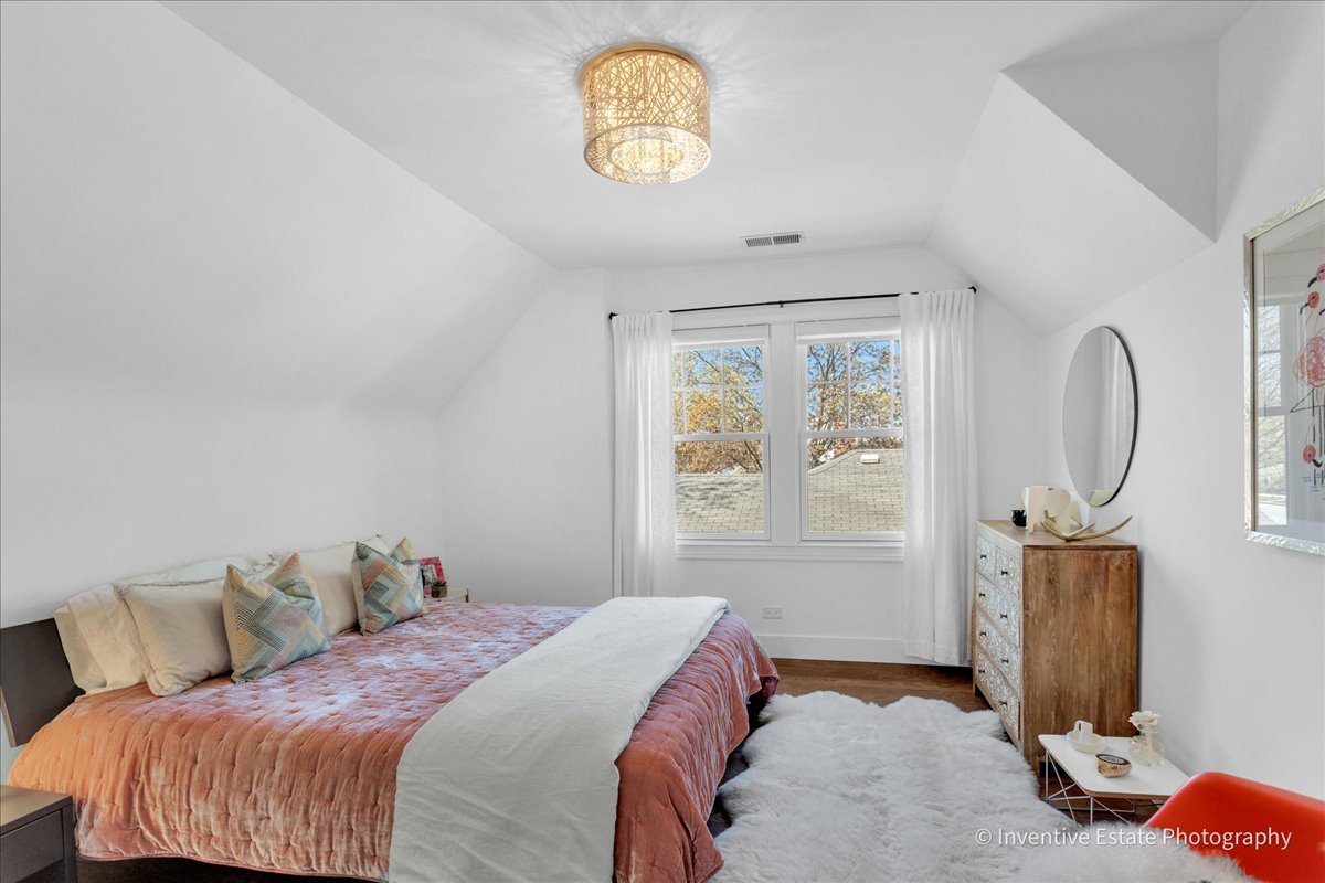305 Clinton Avenue Elmhurst, IL 60126 - Photo 17 of 31 a bedroom with a bed and a window