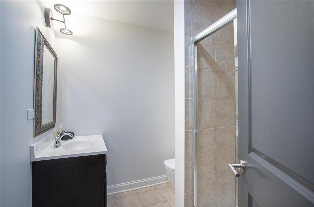305 Clinton Avenue Elmhurst, IL 60126 - Photo 23 of 31 a bathroom with a sink and mirror