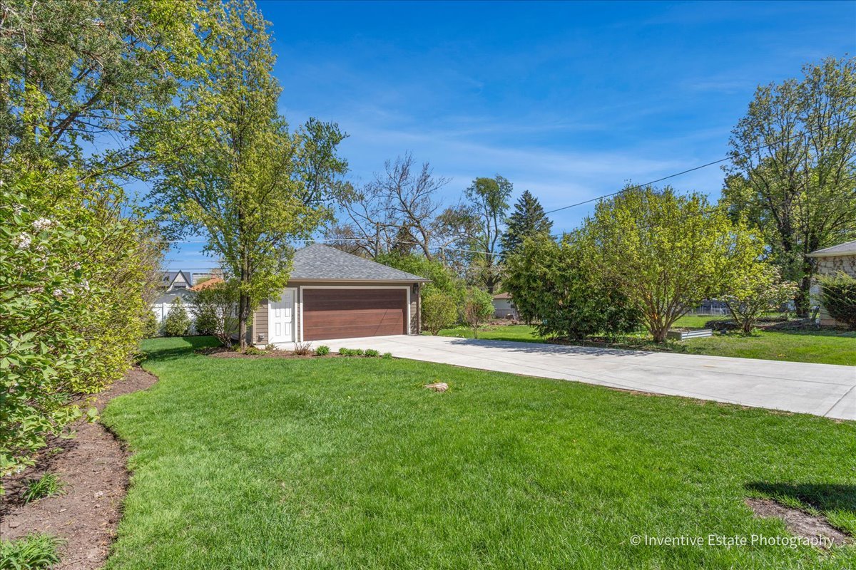 305 Clinton Avenue Elmhurst, IL 60126 - Photo 27 of 31 a front view of a house with a yard and trees