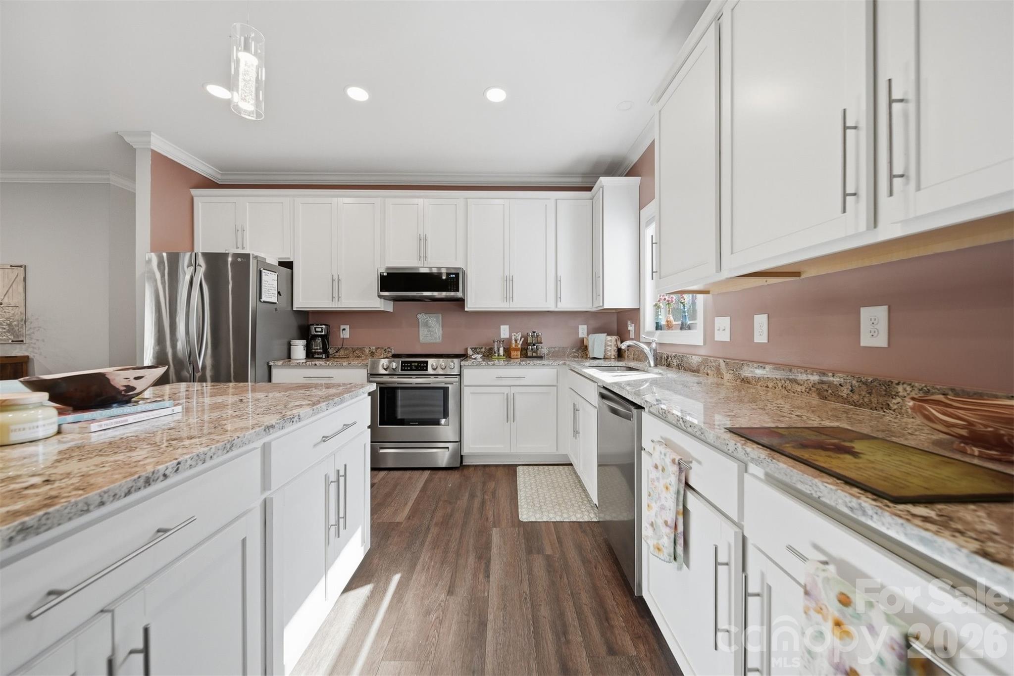 976 Amherst Road Morganton, NC 28655 - Photo 13 of 38 a kitchen with kitchen island granite countertop a sink stainless steel appliances and cabinets
