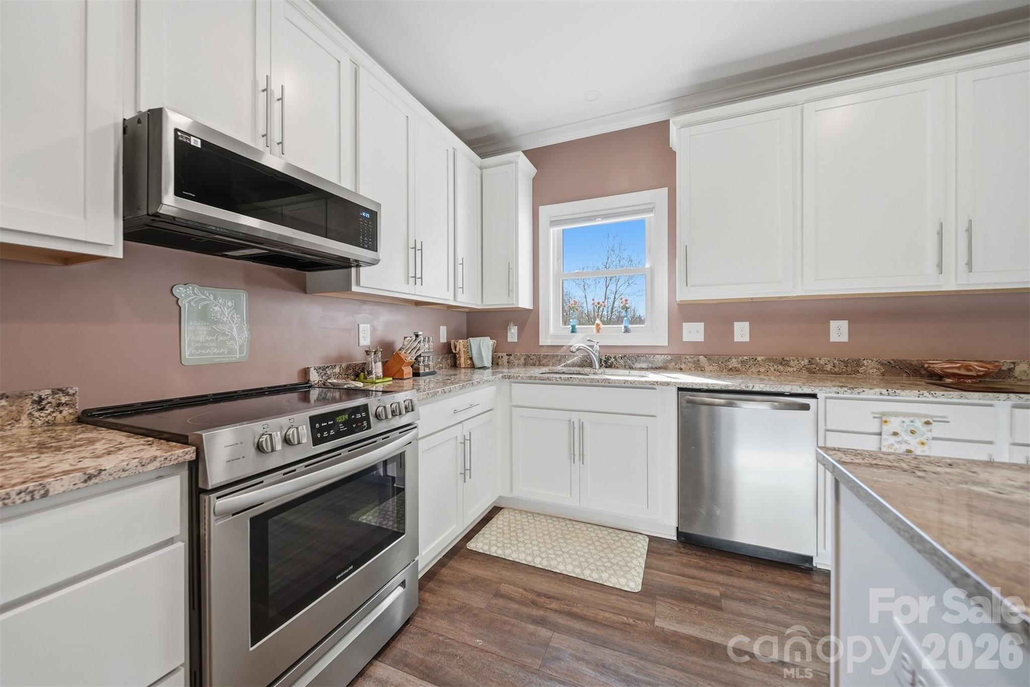 976 Amherst Road Morganton, NC 28655 - Photo 14 of 38 a kitchen with stainless steel appliances granite countertop a stove a sink and a microwave
