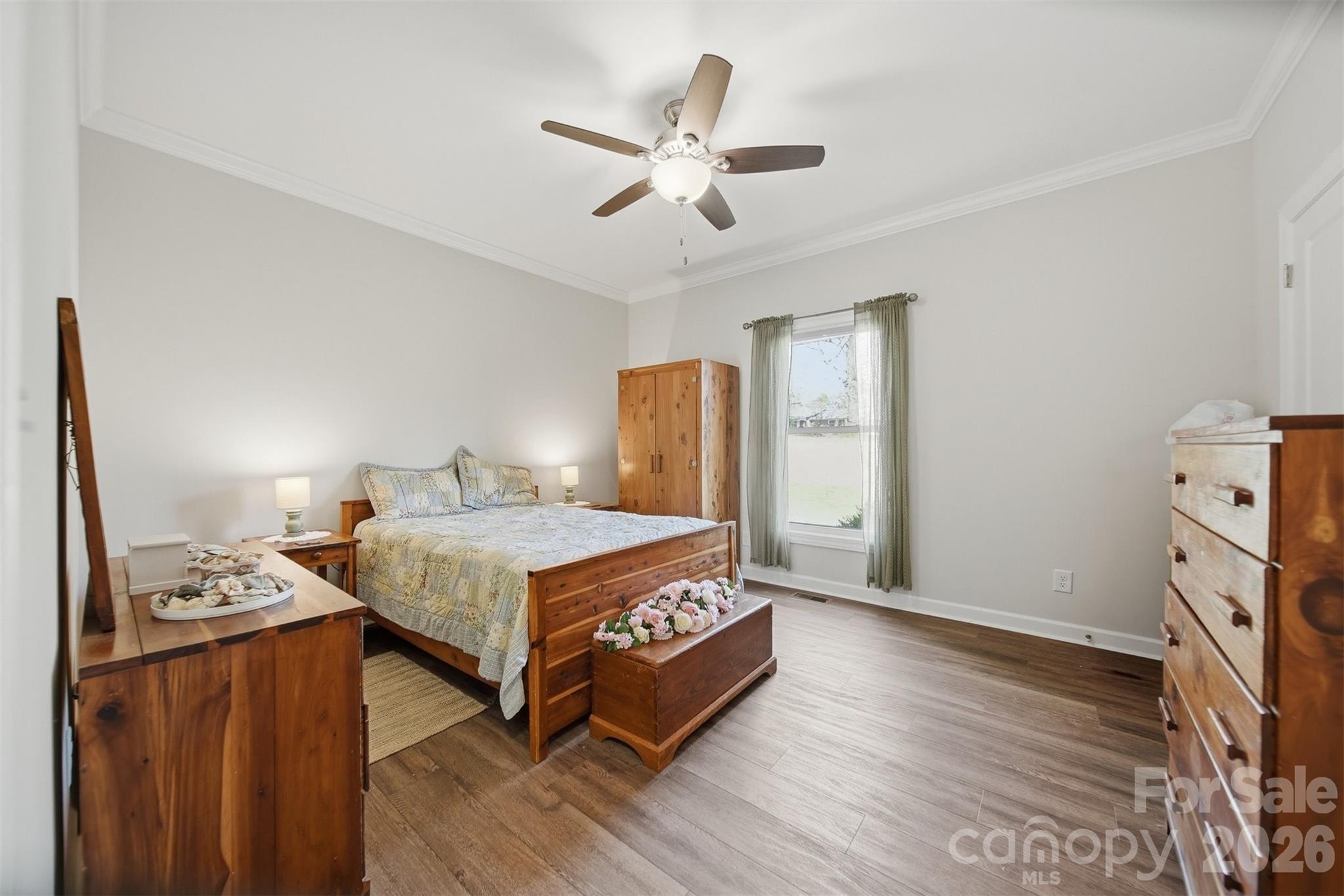 976 Amherst Road Morganton, NC 28655 - Photo 21 of 38 a bedroom with a bed and a chandelier