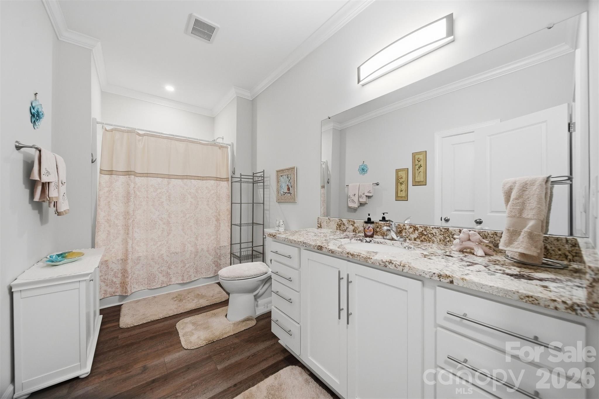 976 Amherst Road Morganton, NC 28655 - Photo 22 of 38 a bathroom with a sink a toilet a mirror and shower
