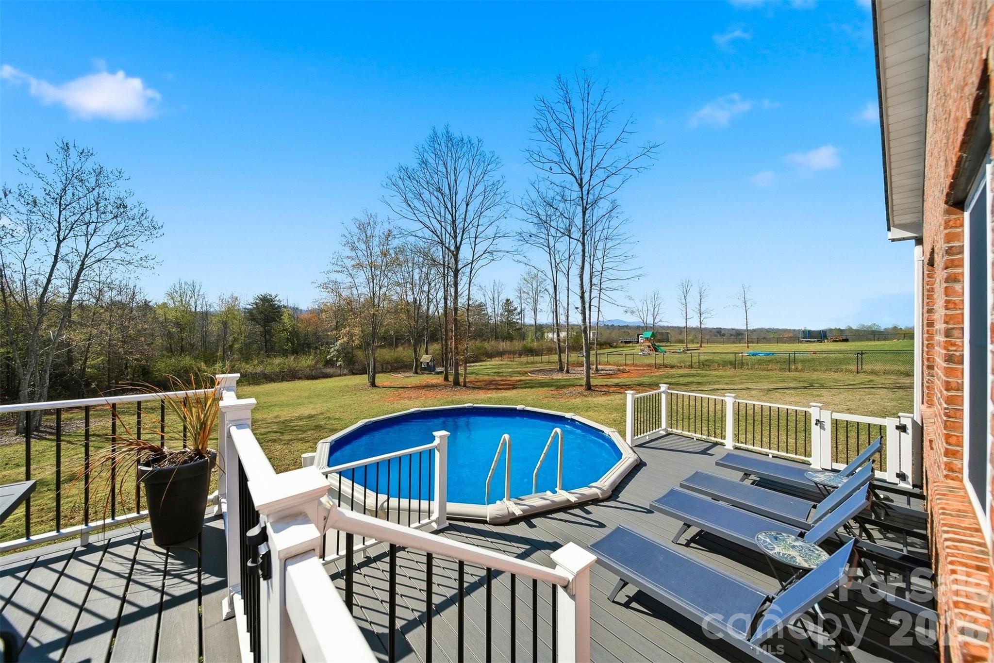 976 Amherst Road Morganton, NC 28655 - Photo 27 of 38 a view of a roof deck with couches and wooden fence