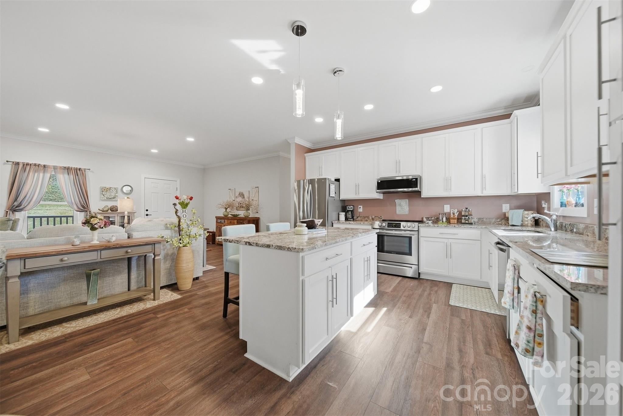 976 Amherst Road Morganton, NC 28655 - Photo 10 of 38 a kitchen with white cabinets and stainless steel appliances