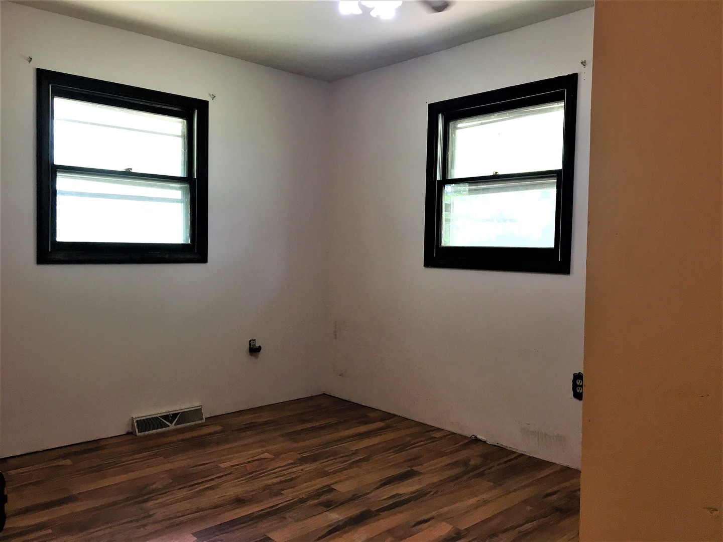 6939 North Junction Road Davis Junction, IL 61020 - Photo 15 of 31 an empty room with wooden floor and windows