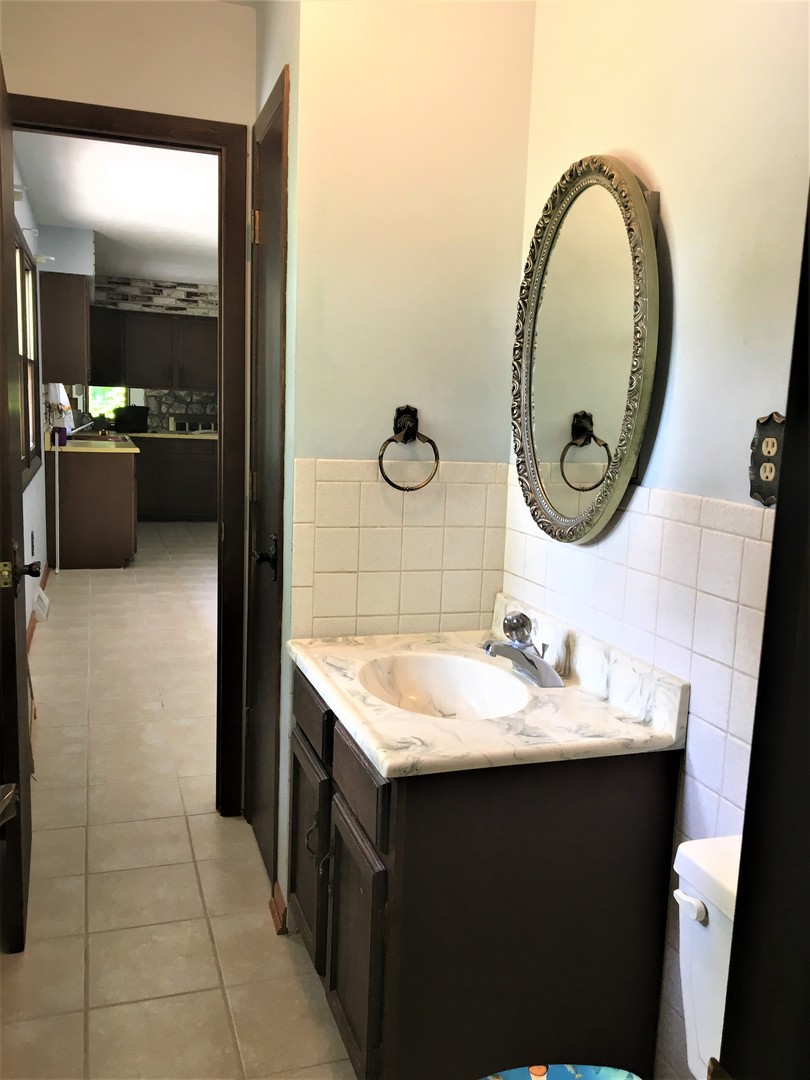 6939 North Junction Road Davis Junction, IL 61020 - Photo 18 of 31 a bathroom with a sink and a mirror