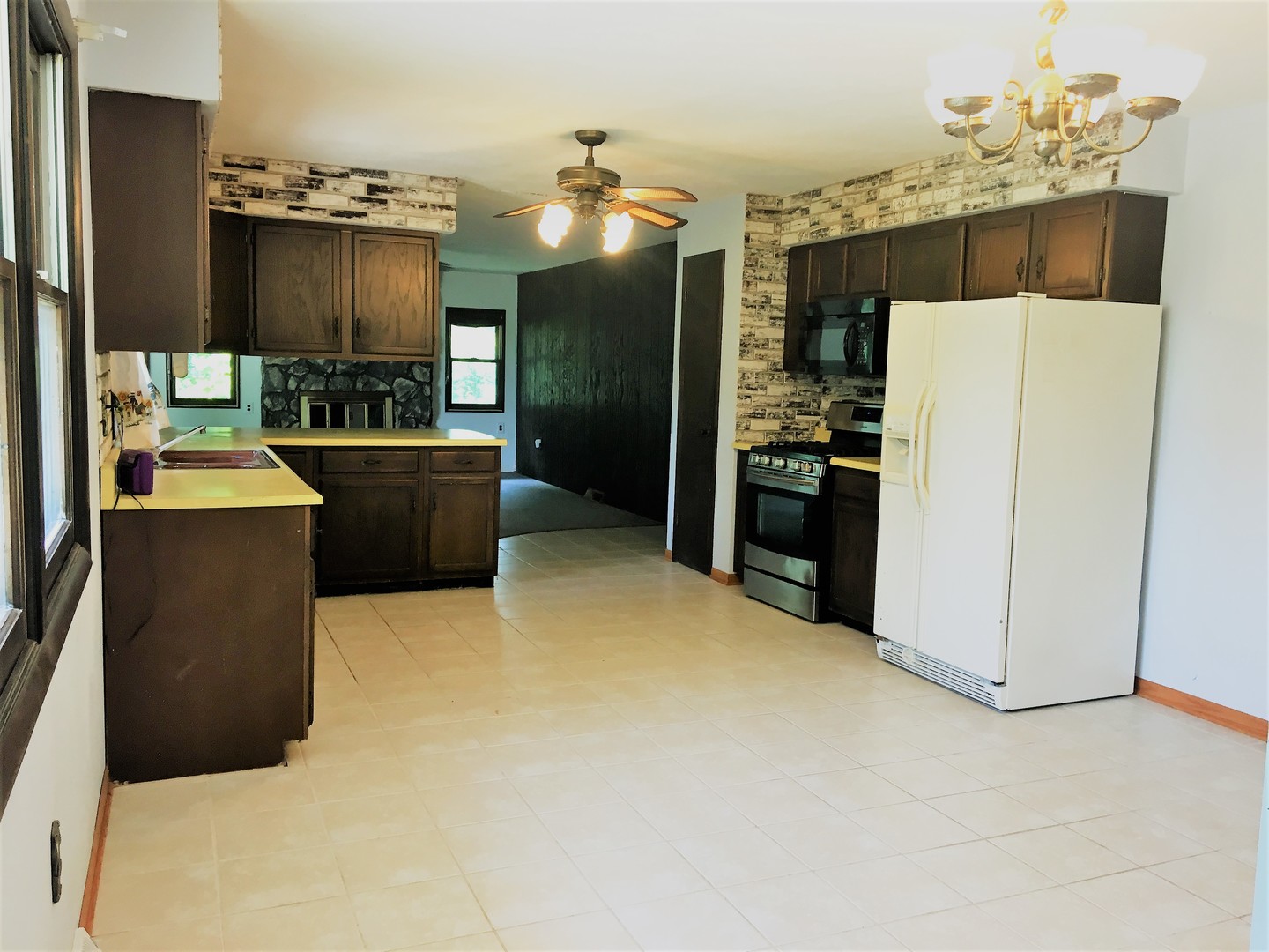 6939 North Junction Road Davis Junction, IL 61020 - Photo 5 of 31 a large kitchen with a refrigerator a stove top oven a sink and dishwasher