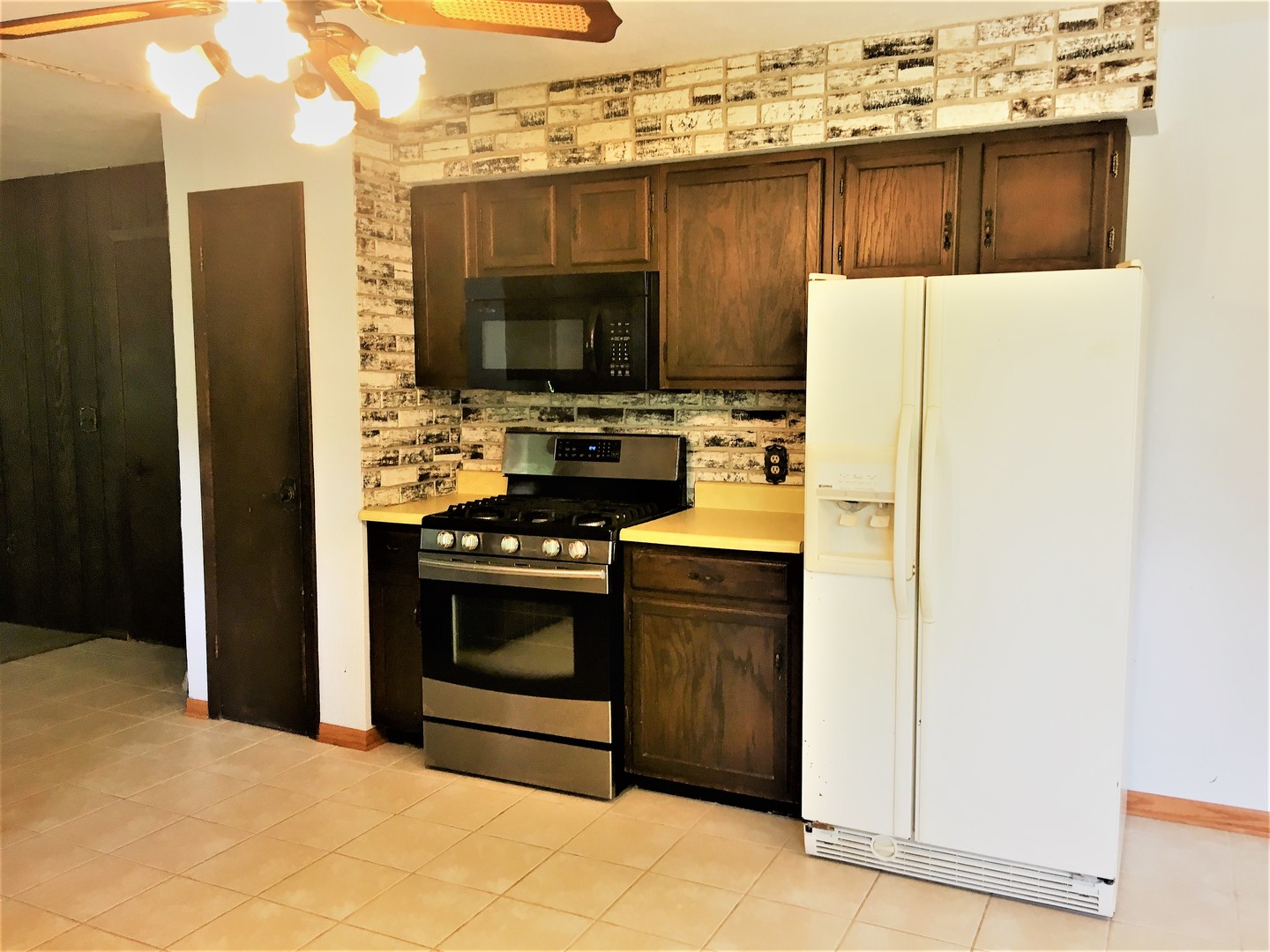 6939 North Junction Road Davis Junction, IL 61020 - Photo 7 of 31 a kitchen with stainless steel appliances a stove microwave and refrigerator