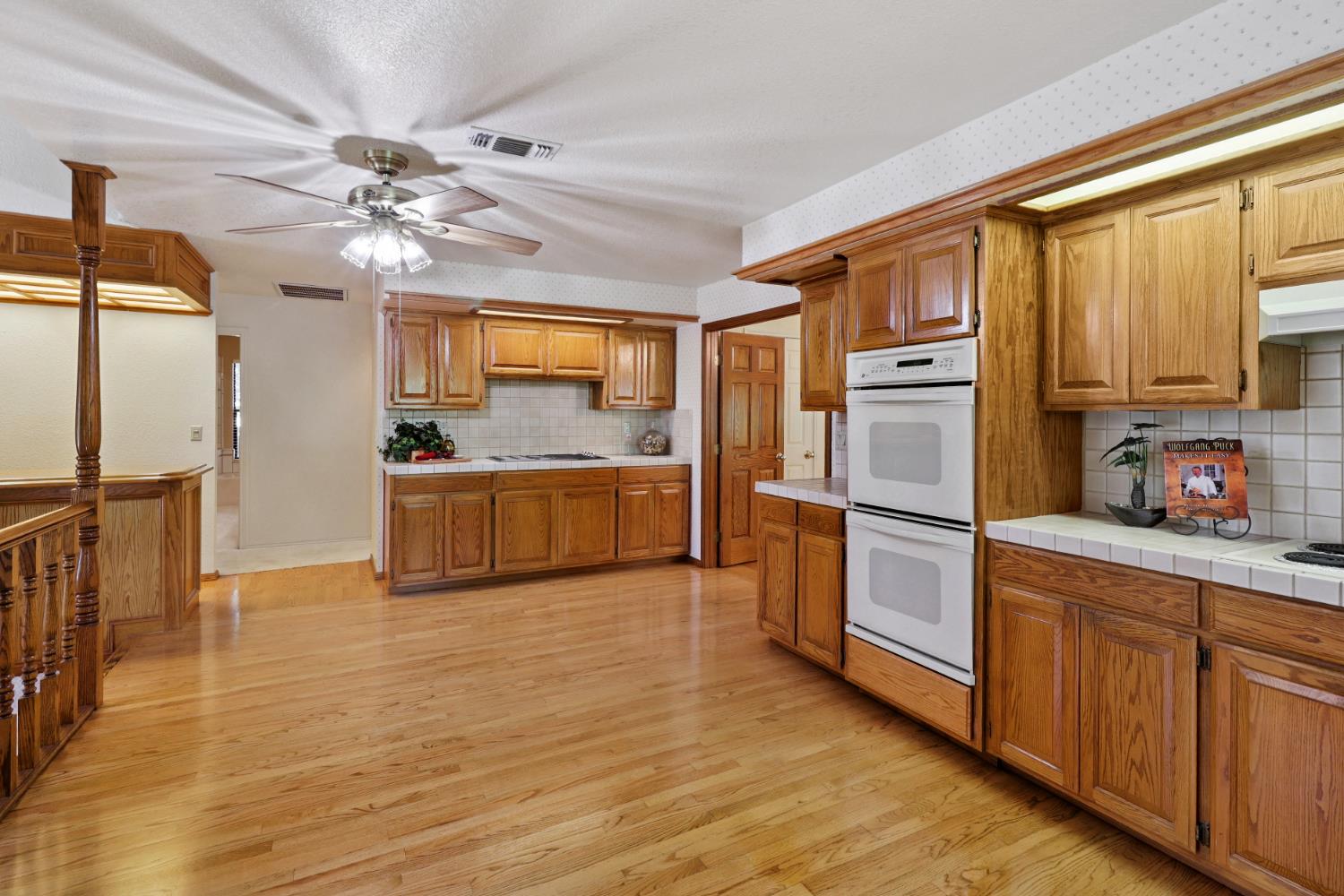 6798 Terreno Drive Rancho Murieta, CA 95683 - Photo 22 of 63 a kitchen with stainless steel appliances a refrigerator and a stove top oven